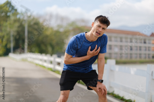 Fitness health concept of a runner experiencing breathing difficulty during outdoor training.