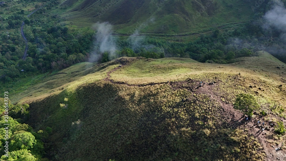 Obraz premium Aerial View of Scenic Green Mountain Ridge with Tropical Valley and Morning Mist