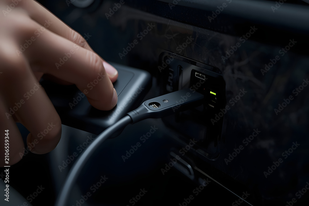 Fototapeta premium Person Plugging Charger into Power Bank