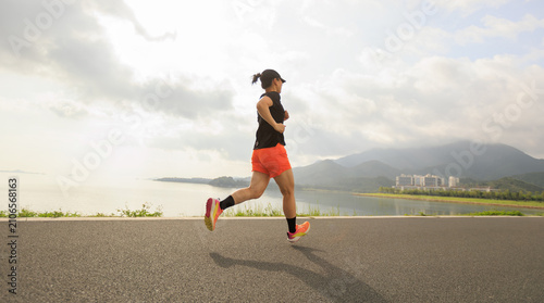 Fitness woman runner running at seaside