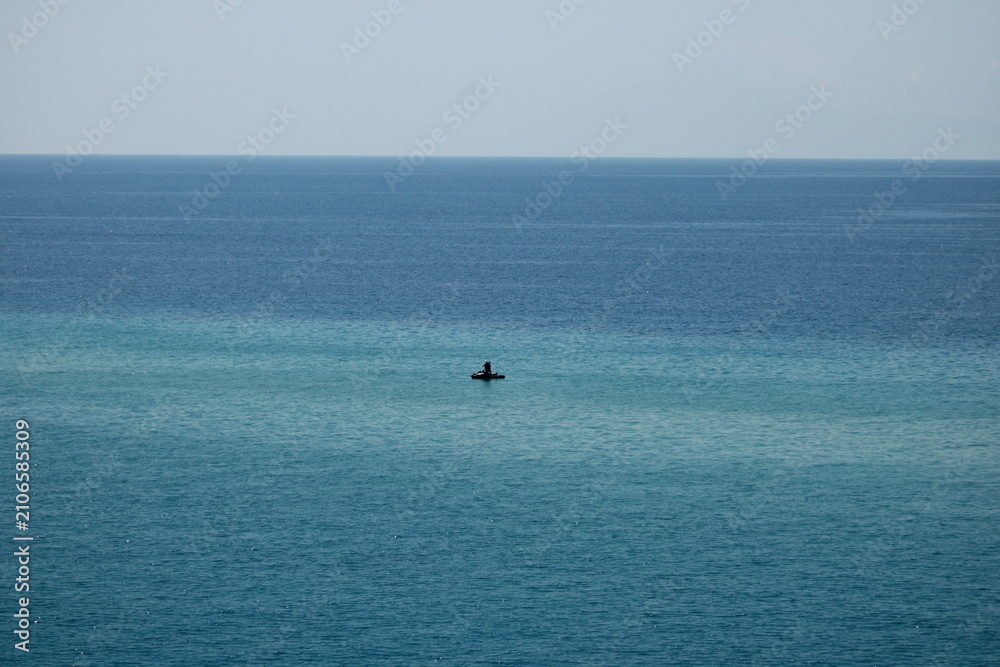 Fototapeta premium Jet Ski Riding Across Calm Turquoise Sea with Copy Space