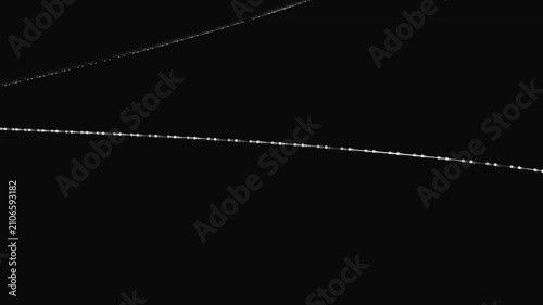 Glowing light trails form intersecting geometric paths across the dark void to simulate motion and velocity