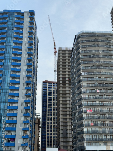 High-rise buildings and construction crane between modern apartment towers.