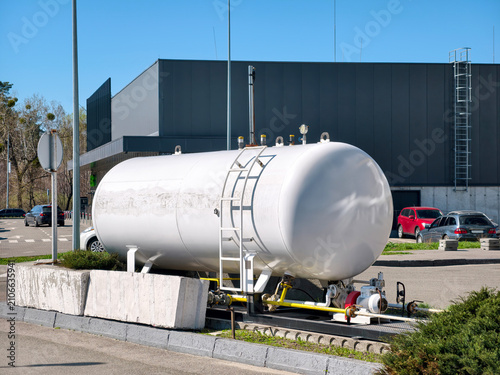Gas storage tank with regulator and safety equipment at modern fueling station