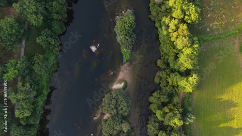 Lima River Winding Through Lush Green Trees And Farm Fields In The Valley Near Ponte de Lima, Portugal. aerial topdown shot