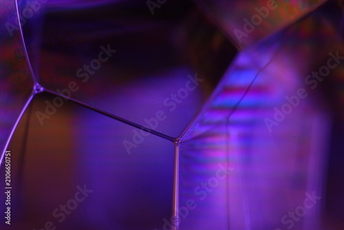 Fotografie Geometric foam vertex with violet prism light refractions