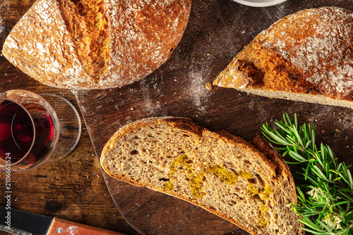 Homemade artisan sourdough bread loaf on a rustic wooden cutting board