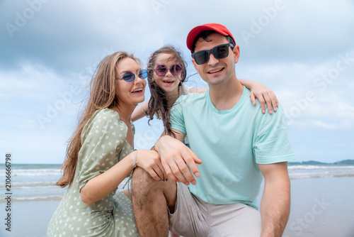 Bild auf Leinwand Parents and daughter share meaningful moments at the beach celebrating love trust emotional connection and unforgettable summer holiday experiences