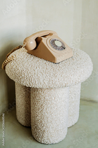old fashioned beige phone on the beige sofa 