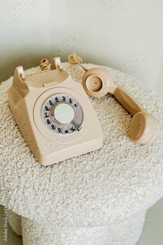 old fashioned beige phone on the beige sofa 