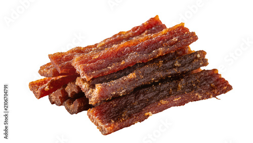 Fotografie Isolated appetizing stack of sweet and savory Asian dried meat jerky strips, del