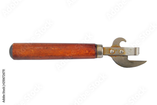 Old can opener with wooden handle isolated on white background.
Vintage kitchen tool. Metal kitchen gadget.