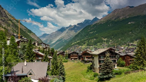 Zermatt Switzerland alpine village timelapse featuring rushing clouds over Swiss Alps mountain valley and chalet architecture