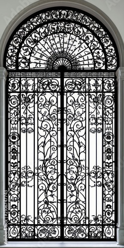 ornate arched wrought iron double gate with intricate scrollwork and floral motifs conveying elegant historic formality