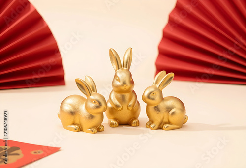 Three golden rabbit figurin...