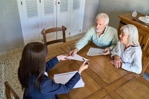 Retirement Planning And Financial Protection: Senior Couple Discussing Estate With Advisor For Long-Term Security
