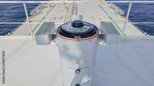 Photography High angle view of gyro compass repeater on vessel navigation bridge wing facing