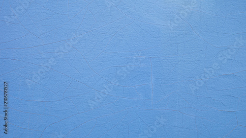 Cracked light blue paint texture on old wood wall background