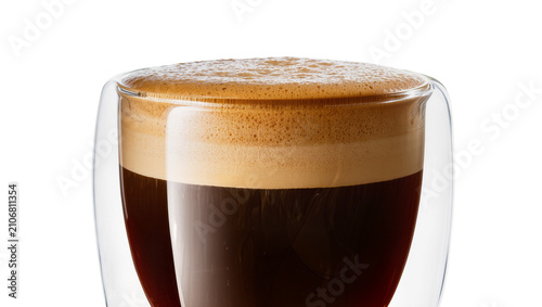Isolated delicious espresso coffee in a modern double wall glass cup with rich golden crema