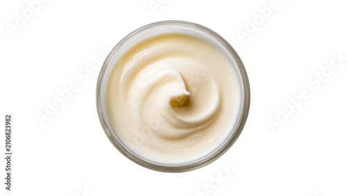 Isolated overhead view of a jar of rich cosmetic cream with a smooth creamy swirl texture