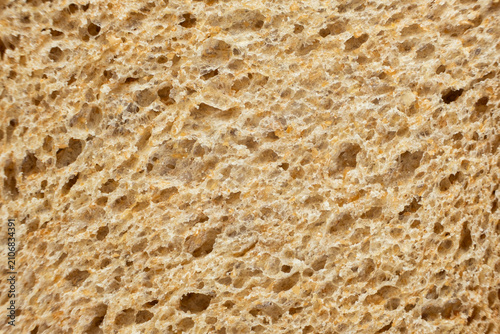 Macro texture of whole wheat bread crumb, detailed food background.