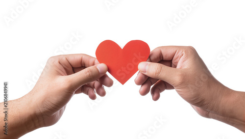 Fotografía Isolated two human hands tenderly holding a vibrant red heart shape, symbolizing