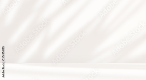 Empty cream beige room studio with shadow of leaves for product presentation. Autumn background. Summer tropical backdrop. Cosmetic showroom.