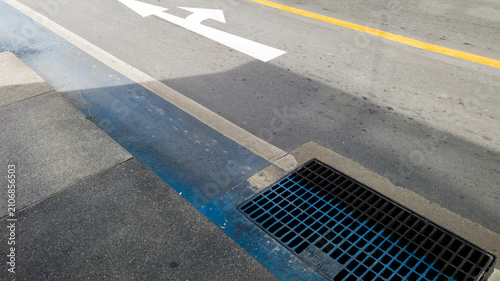 White direction arrow on asphalt road with copy space, business direction and traffic navigation concept