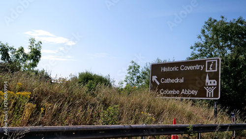 Photos Brown tourist road sign, direction sign, British highway signage pointing to His