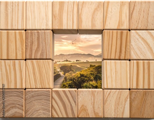 Wood blocks frame a serene rural landscape