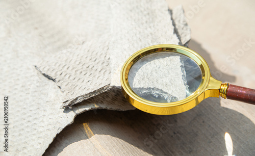 Magnifying glass showing old asbestos. Health problems