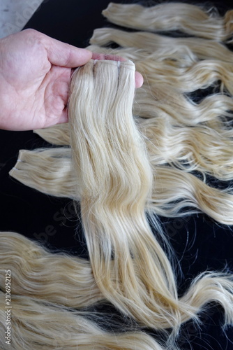 Blonde Hair Extensions Collection Isolated on Black Background for Beauty Salon