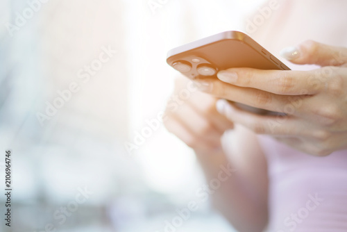 woman holds smart phone in her hands and scrolls through the news feed. Close up of hand uses mobile. point finger on screen, texting text message.	