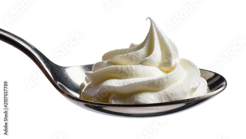 Isolated elegant scoop of fresh delicious whipped cream on a polished silver spoon