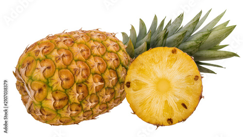 Isolated whole ripe pineapple with a fresh half slice, juicy and sweet tropical fruit