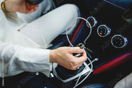 close up of woman hand shifting gears in luxury car