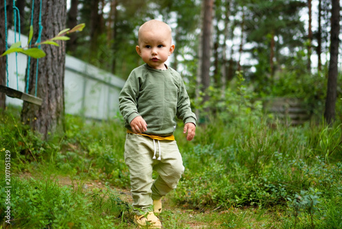 Konstfotografi Curious child examining ground outdoors with engaged focused attention