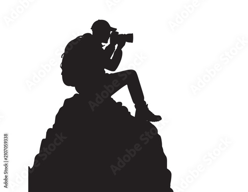 Obraz na płótnie Photographer Silhouette With Camera On Rocky Outcrop Black And White