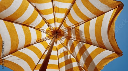 Bright yellow and white stripes dominate the umbrella's canopy.