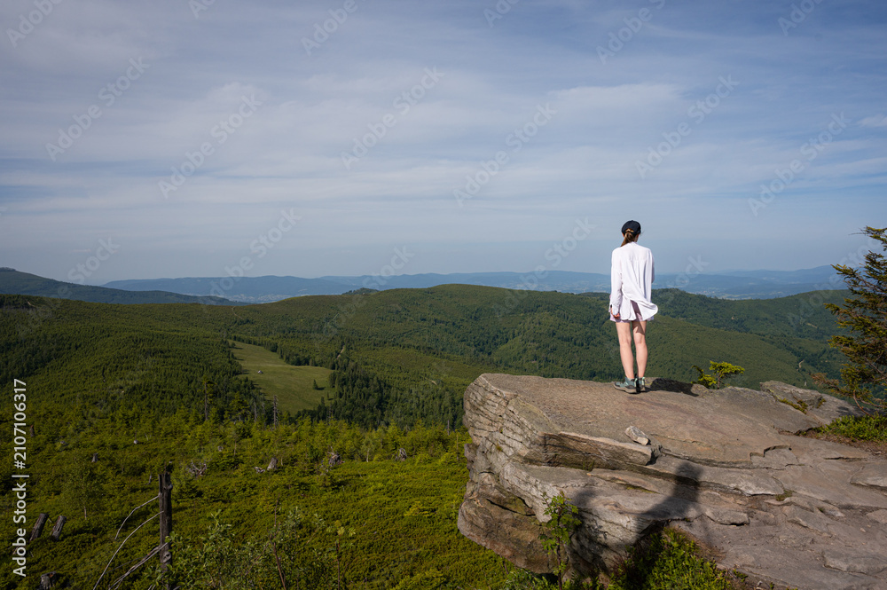 Obraz premium Young Woman Standing on Rock Edge Enjoying Mountain Panorama View, Hiking Lifestyle