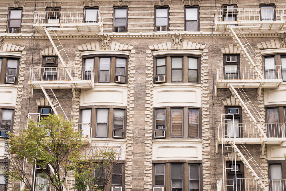Fototapeta premium Historic New York City Apartment Building Facade with Fire Escapes