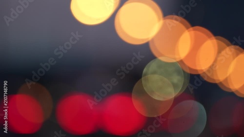 Abstract blurred bokeh lights background with colorful glowing circles, urban night atmosphere and defocused illumination for creative design projects