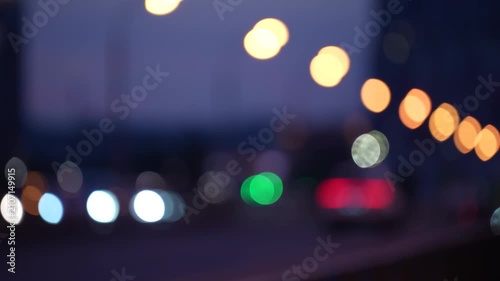 Abstract blurred city lights with colorful bokeh and traffic atmosphere at night, modern urban background showing motion, energy and metropolitan life