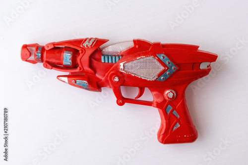 Fotografía Red vintage plastic toy ray gun with sci-fi design isolated on white background