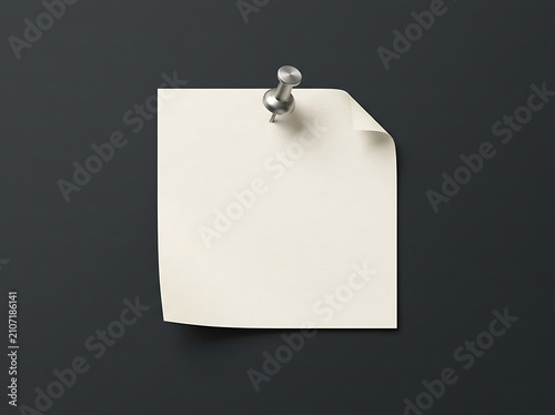 Cream sticky note pinned on a dark grey wall