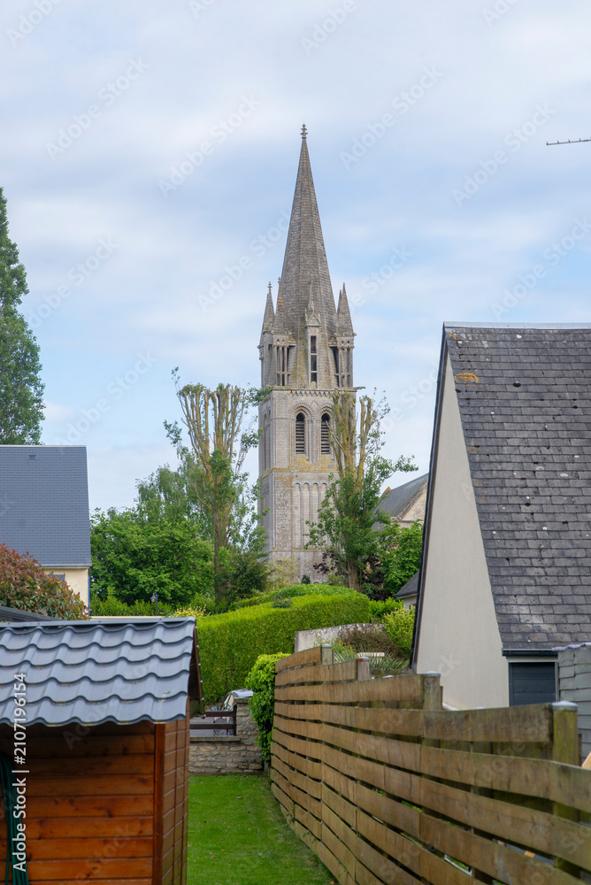 Obraz premium Gothic Church Spire Rising Above Village Rooftops