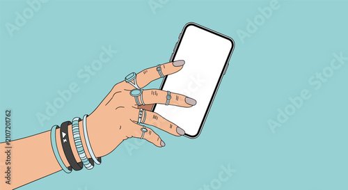 Hand of a stylish woman decorated with silver rings and turquoise bracelets holding a blank smartphone mockup.