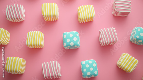 Pastel striped and polka dot petit fours arranged on pink background, colorful square cakes create playful, cheerful, and whimsical dessert pattern for festive celebration