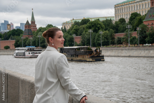 Photography Woman glances back beside Moscow River on Sofiyskaya Embankment with Kremlin skyline in background