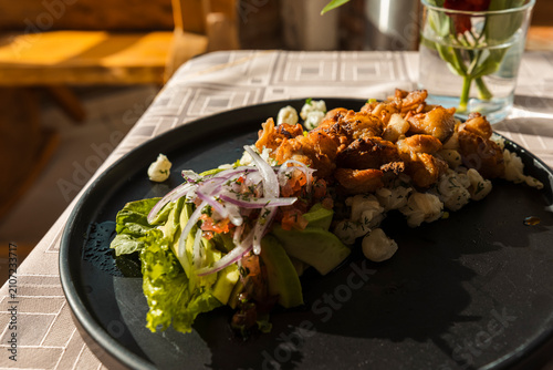 Bild auf Leinwand Gourmet presentation of traditional mote with crispy pork chicharron, avocado, a